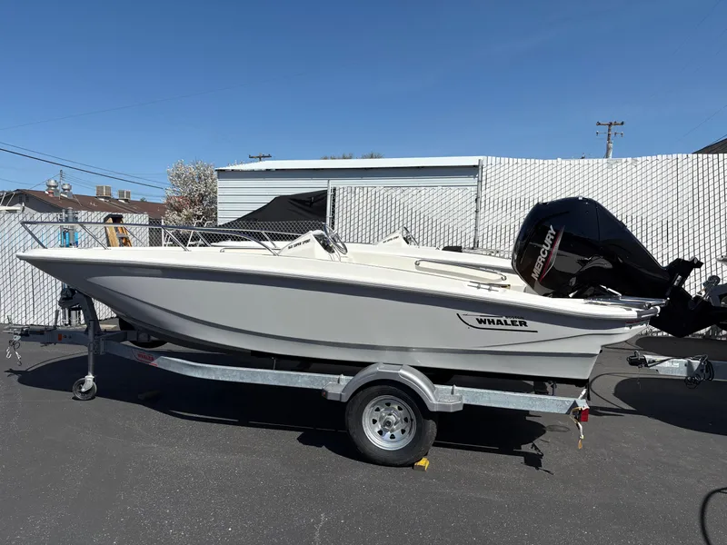 The Image of 2025 Boston Whaler 160 Super Sport boat on trailer, parked outdoors. - 1