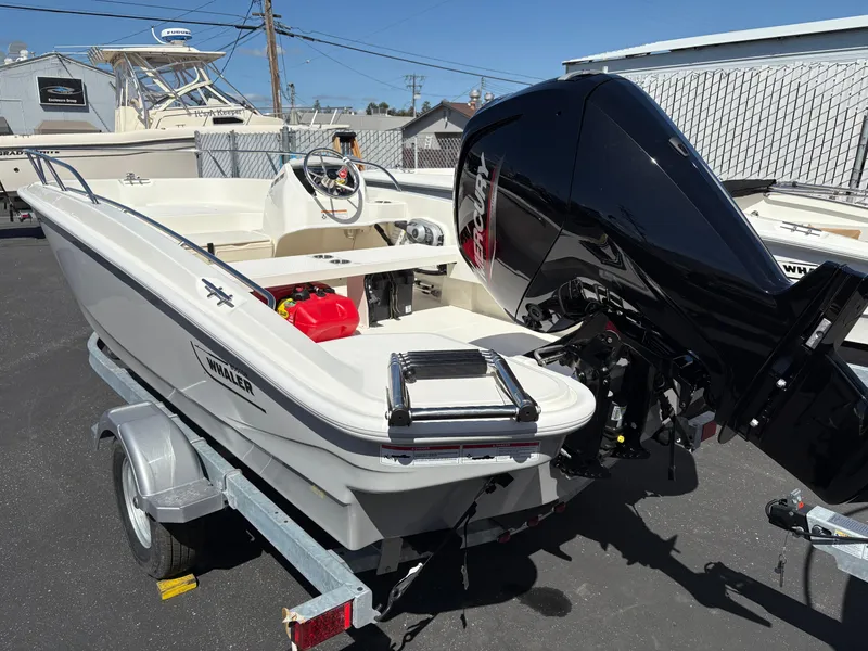 Slide: The Image of 2025 Boston Whaler 160 Super Sport boat on trailer, featuring powerful outboard motor. - 3