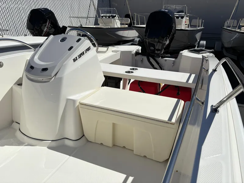 Slide: The Image of 2025 Boston Whaler 160 Super Sport boat interior with seating and console. - 6