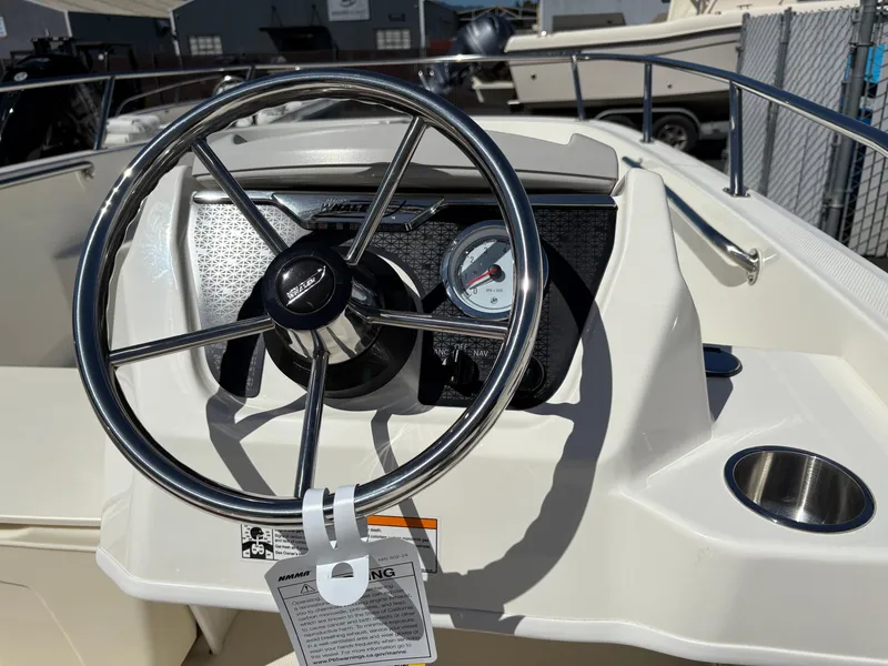 Slide: The Image of 2025 Boston Whaler 160 Super Sport steering wheel and dashboard close-up. - 8