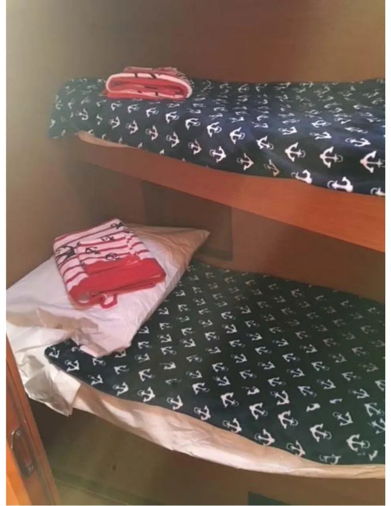 Slide: The Image of Bunk beds with anchor-themed bedding in 2017 Jeanneau Sun Odyssey 44 DS yacht cabin. - 10