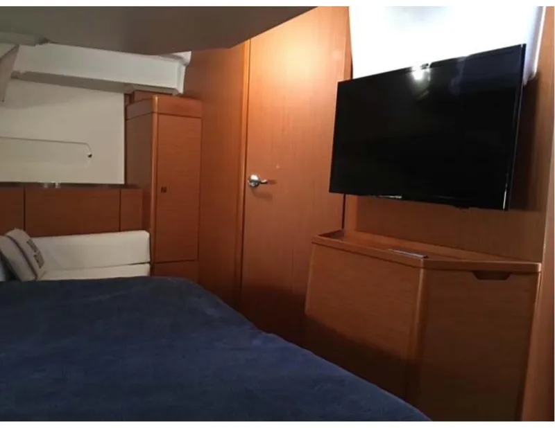 Slide: The Image of Interior of 2017 Jeanneau Sun Odyssey 44 DS with TV and wooden cabinetry. - 11
