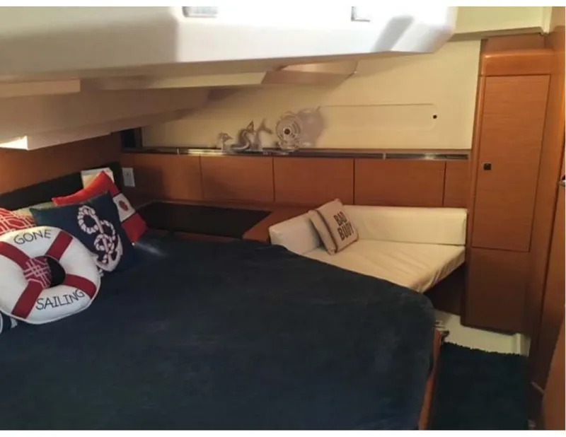 Slide: The Image of 2017 Jeanneau Sun Odyssey 44 DS cabin with nautical decor and cozy seating. - 12