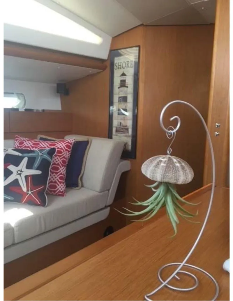 Slide: The Image of Interior of 2017 Jeanneau Sun Odyssey 44 DS with nautical decor and hanging plant. - 13