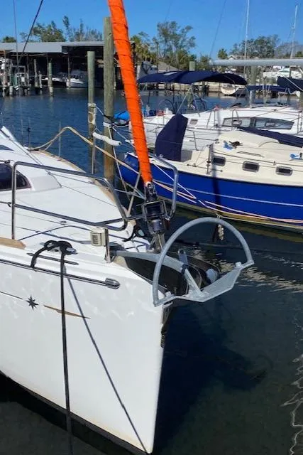 Slide: The Image of 2017 Jeanneau Sun Odyssey 44 DS sailboat docked in marina, featuring sleek design and vibrant orange sail. - 28