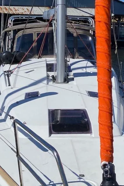 Slide: The Image of 2017 Jeanneau Sun Odyssey 44 DS sailboat with orange mast cover, docked in marina. - 3
