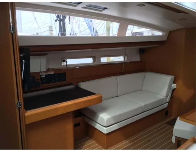 Slide: The Image of Interior of 2017 Jeanneau Sun Odyssey 44 DS yacht with white seating and wooden accents. - 6