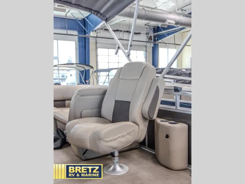 Slide: The Image of 2023 Party Barge 22 RF XP3 boat interior with plush seating in showroom. - 10