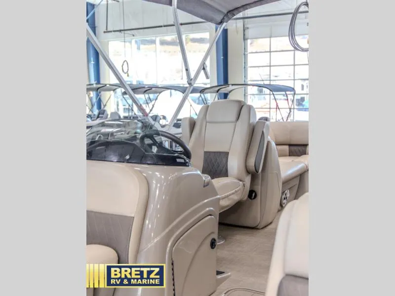 Slide: The Image of 2023 Party Barge 22 RF XP3 interior with beige seating and steering console. - 11