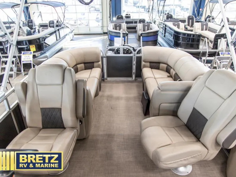 Slide: The Image of 2023 Party Barge 22 RF XP3 interior with beige seating at Bretz RV & Marine showroom. - 8