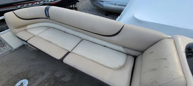Slide: The Image of 2016 Sun Tracker PB 22 RF boat seating, beige upholstery, outdoor setting. - 11