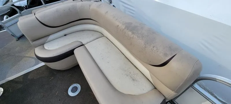 Slide: The Image of 2016 Sun Tracker PB 22 RF boat seating with beige upholstery and black accents. - 12