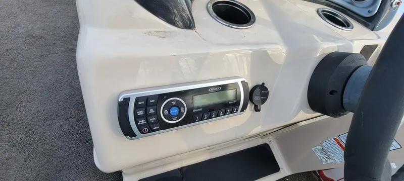 Slide: The Image of 2016 Sun Tracker PB 22 RF boat dashboard with stereo system and cup holders. - 8