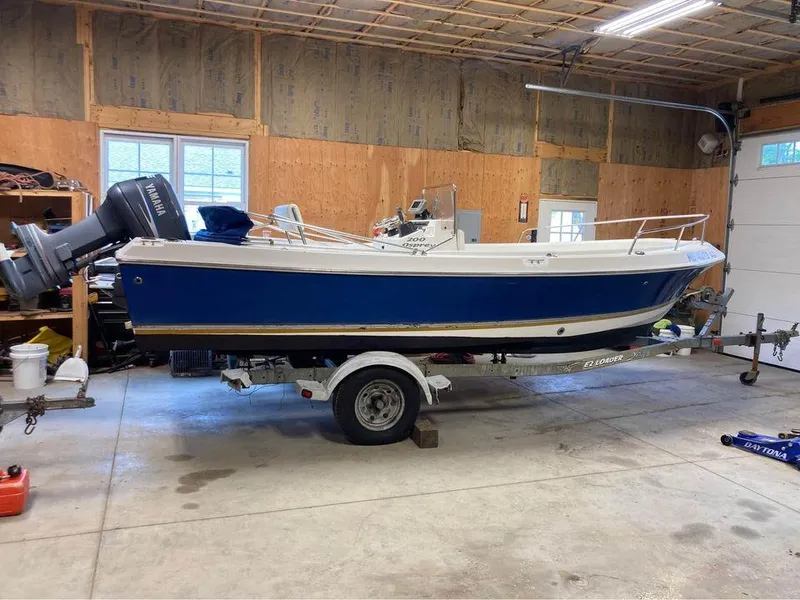 Slide: The Image of 2003 Aquasport 200 Osprey boat on trailer in garage. - 4