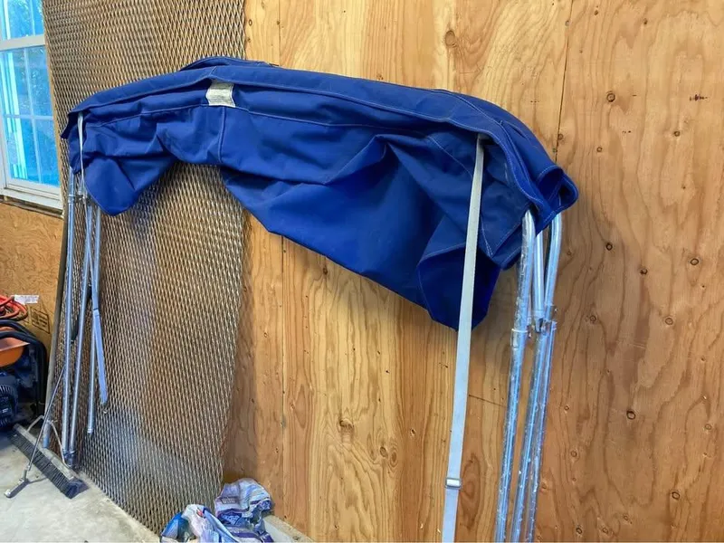 Slide: The Image of Blue boat canopy for 2003 Aquasport 200 Osprey, stored indoors. - 5