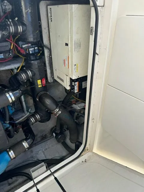 Slide: The Image of Engine room of a 2002 Silverton 330 Sport Bridge with visible machinery and components. - 18