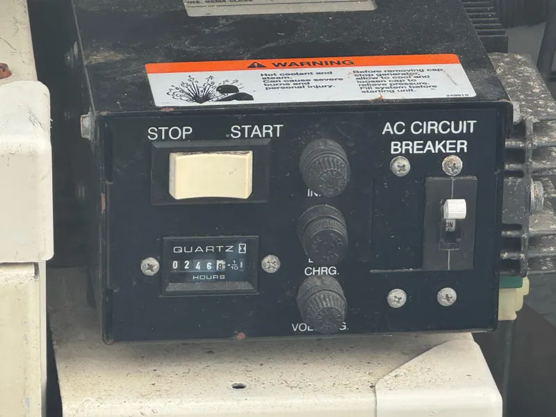 Slide: The Image of Control panel of a 2002 Silverton 330 Sport Bridge with AC circuit breaker and hour meter. - 20