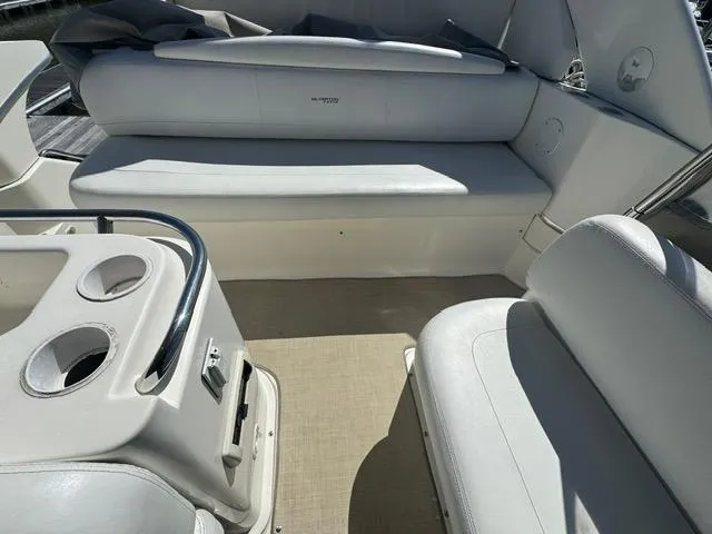 Slide: The Image of 2002 Silverton 330 Sport Bridge interior with white seating and cup holders. - 7