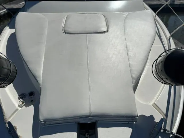 Slide: The Image of 2002 Silverton 330 Sport Bridge boat with white cushioned deck area. - 8