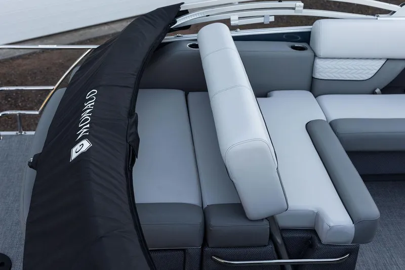Slide: The Image of 2025 Godfrey Monaco 235 SFL boat interior with gray seating and black cover. - 12