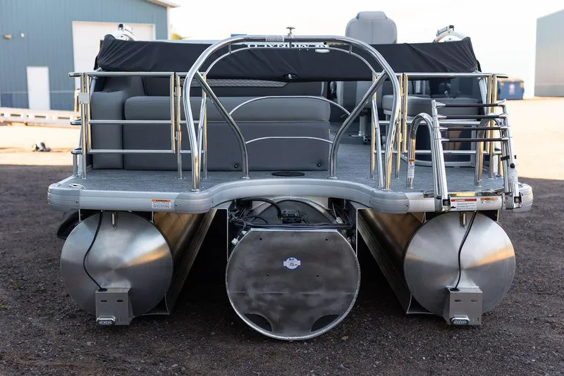 Slide: The Image of 2025 Godfrey Monaco 235 SFL pontoon boat parked outside a blue building. - 3