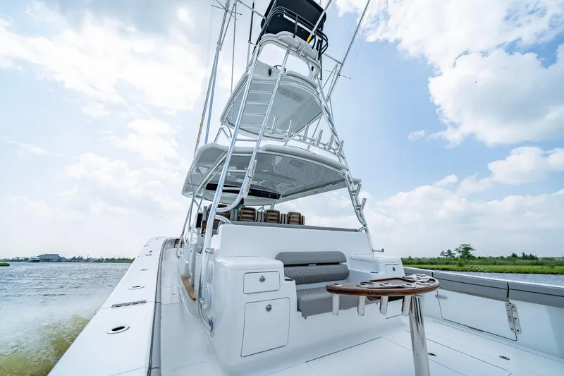 Slide: The Image of 2024 Valhalla V-55 Center Console boat on water, showcasing sleek design and spacious deck. - 10