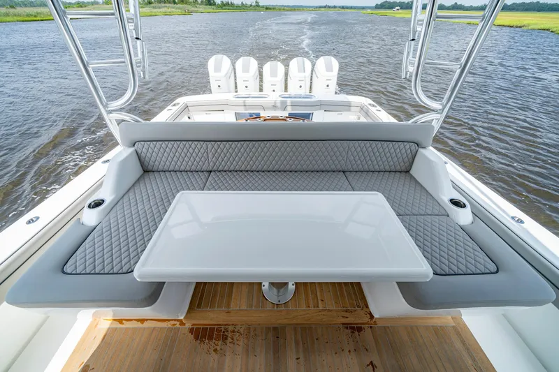 Slide: The Image of 2024 Valhalla V-55 Center Console boat with luxurious seating and table on deck. - 12
