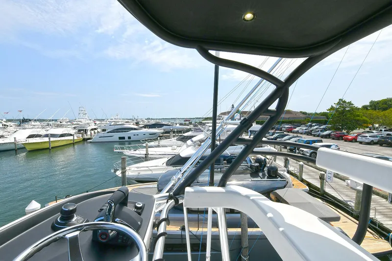 Slide: The Image of 2024 Valhalla Boatworks V-55 Center Console docked at marina, surrounded by yachts. - 22
