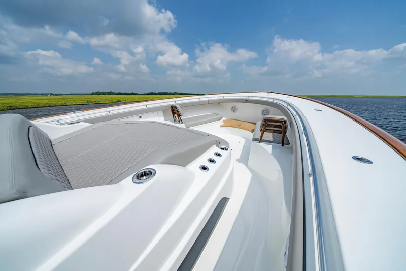 Slide: The Image of 2024 Valhalla V-55 Center Console boat, sleek design, open water, clear sky. - 28