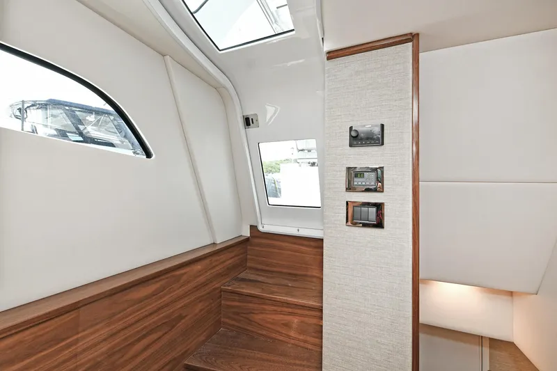 Slide: The Image of 2024 Valhalla V-55 Center Console interior with wooden stairs and modern design. - 30