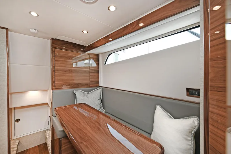 Slide: The Image of 2024 Valhalla V-55 Center Console interior with elegant wood finish and seating area. - 34
