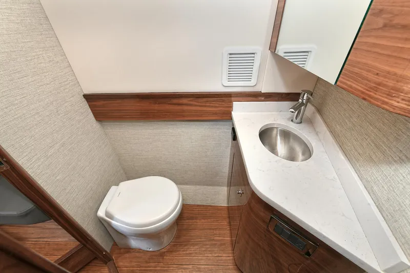 Slide: The Image of 2024 Valhalla V-55 Center Console bathroom with modern sink and toilet. - 36