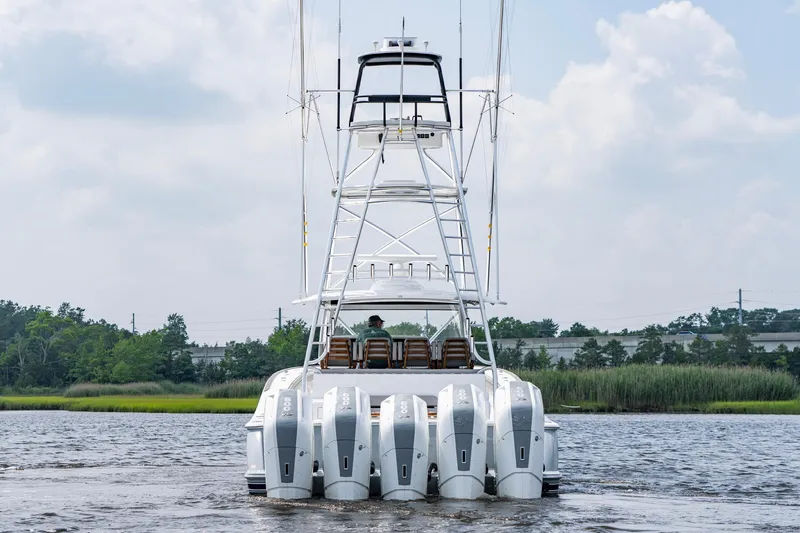 Slide: The Image of 2024 Valhalla V-55 Center Console with multiple outboard engines on a calm waterway. - 6