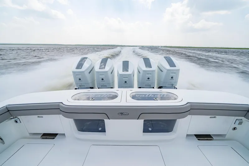 Slide: The Image of 2024 Valhalla V-55 Center Console boat with powerful engines cruising on open water. - 7