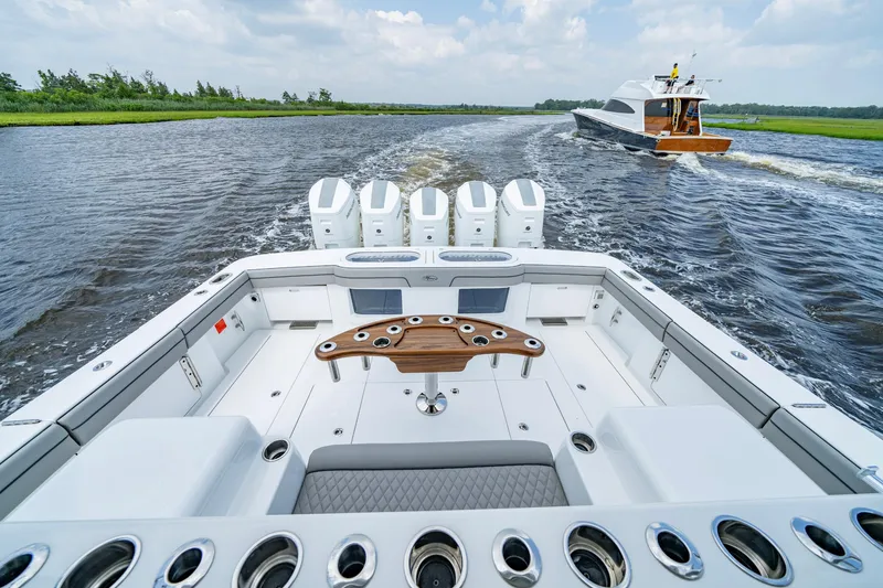 Slide: The Image of 2024 Valhalla V-55 Center Console boat cruising on a scenic waterway. - 9