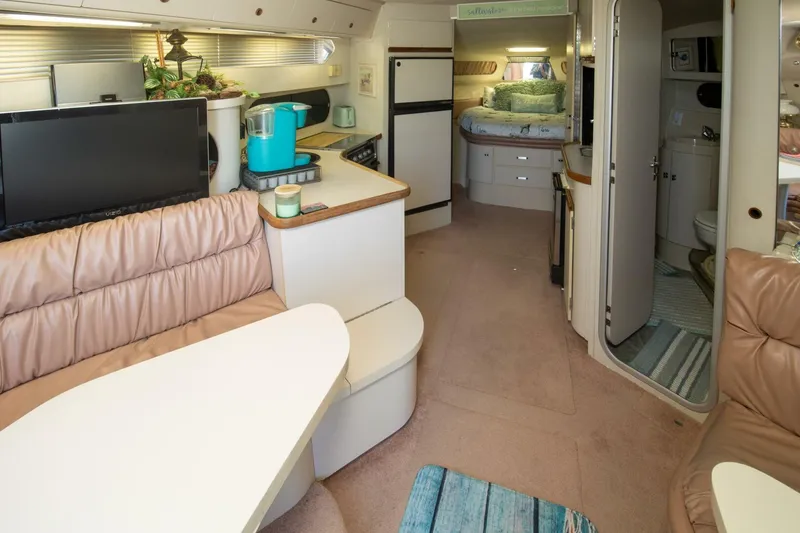 Slide: The Image of Interior of 1989 Carver 340 Santego yacht with cozy seating and modern amenities. - 16