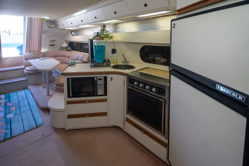 Slide: The Image of Interior of 1989 Carver 340 Santego yacht with kitchen and dining area. - 17