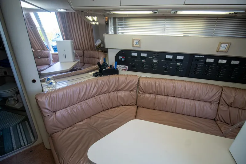 Slide: The Image of Interior of 1989 Carver 340 Santego yacht with plush seating and control panel. - 22