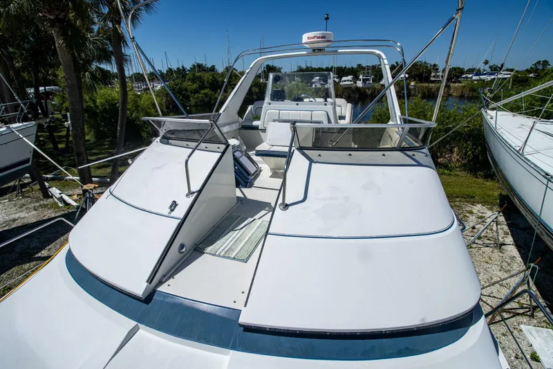 Slide: The Image of 1989 Carver 340 Santego yacht on land, featuring spacious deck and sleek design. - 10