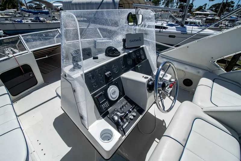 Slide: The Image of 1989 Carver 340 Santego yacht helm with modern navigation equipment and seating. - 12