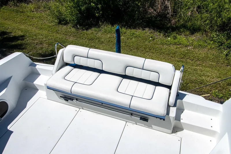 Slide: The Image of White seating on 1989 Carver 340 Santego boat deck, surrounded by greenery. - 14