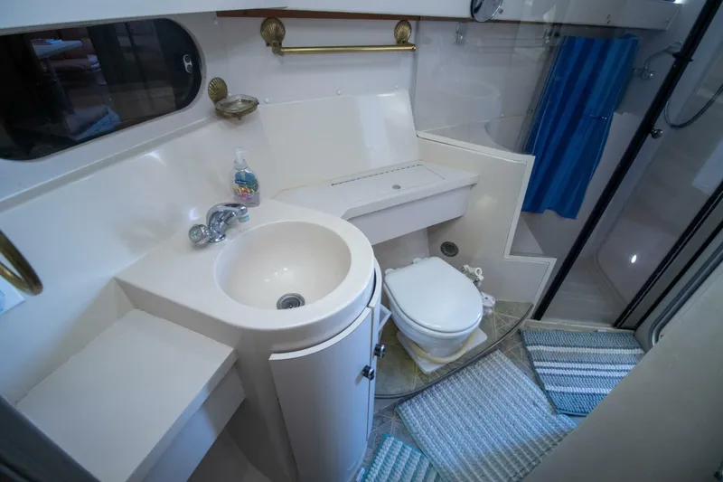 Slide: The Image of 1989 Carver 340 Santego yacht bathroom with sink, toilet, and shower. - 25
