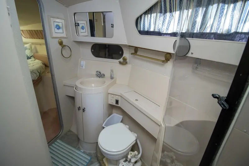 Slide: The Image of 1989 Carver 340 Santego yacht bathroom with sink, toilet, and mirror. - 26