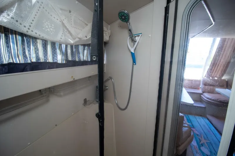 Slide: The Image of 1989 Carver 340 Santego yacht interior with shower and seating area. - 27