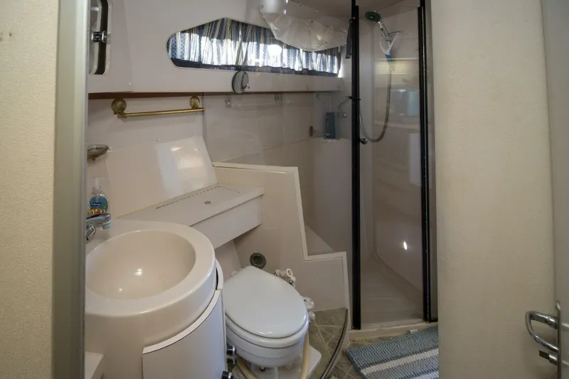 Slide: The Image of 1989 Carver 340 Santego yacht bathroom with shower, sink, and toilet. - 28