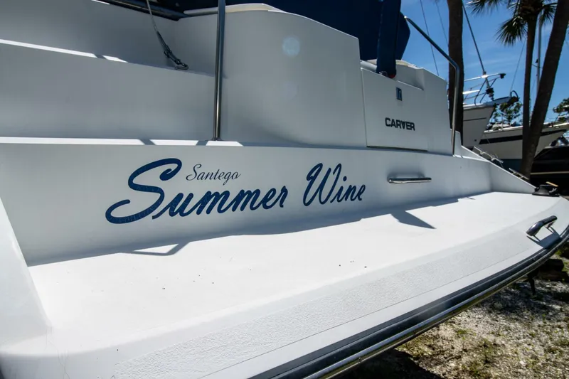 Slide: The Image of 1989 Carver 340 Santego boat named "Summer Wine" docked outdoors. - 7