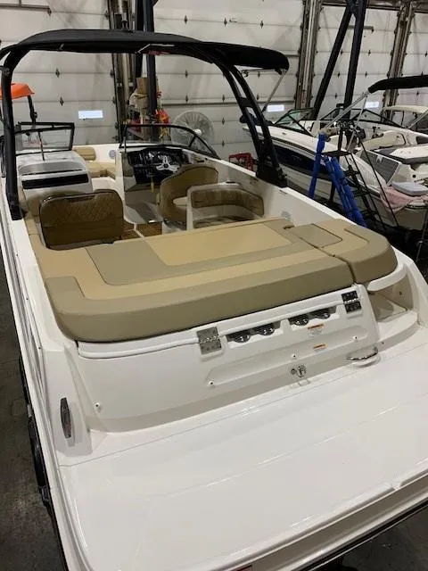 Slide: The Image of 2025 Bayliner VR6 Bowrider I/O boat with beige seating in a showroom. - 3