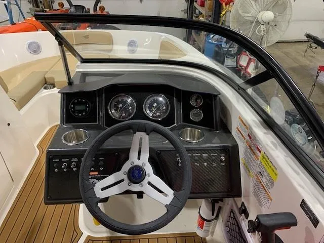 Slide: The Image of 2025 Bayliner VR6 Bowrider I/O dashboard with steering wheel and instrument panel. - 7