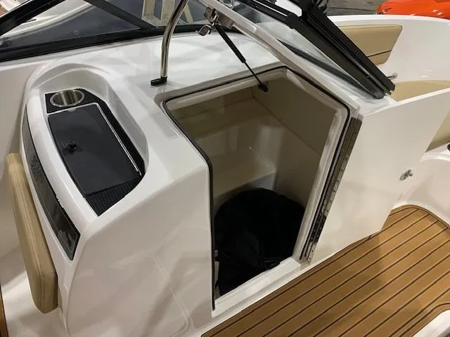 Slide: The Image of 2025 Bayliner VR6 Bowrider I/O interior storage compartment with sleek design and wood flooring. - 8