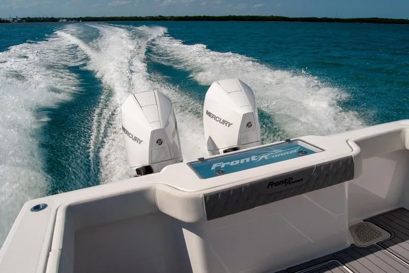 Slide: The Image of 2023 Front Runner 33 Center Console boat with dual Mercury engines on open water. - 13